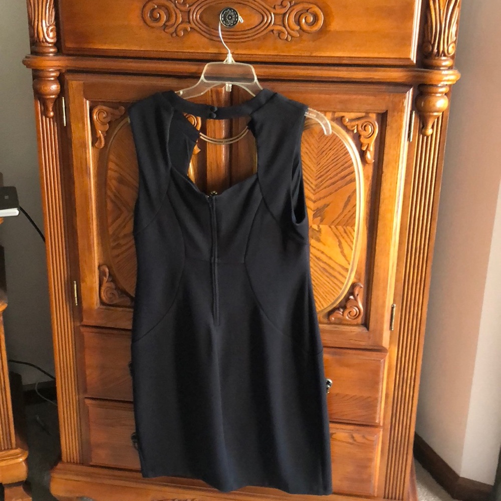 Above knee. Black sleeveless dress
